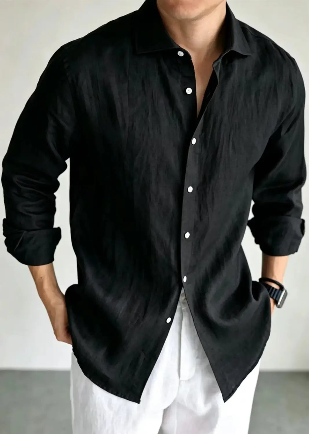 men cotton linen casual button down shirt in black with white buttons and rolled up sleeves made from breathable linen fabric.