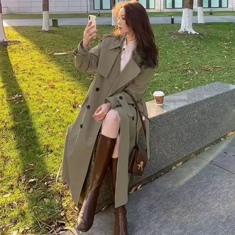 Olive green women double-breasted trench coat with black buttons made of casual windbreaker material for everyday use.