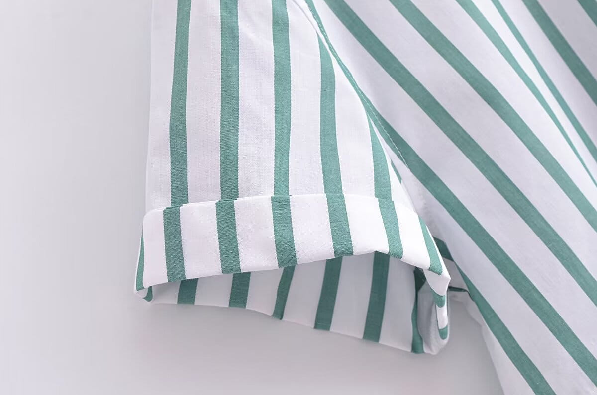 A white and teal striped cotton sleeve with a neatly rolled cuff from the green striped short sleeve crop shirt.