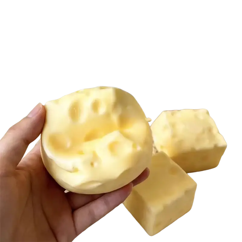 Yellow cheese shaped slow rising squishy toy with textured holes visible from a front angle for stress relief use