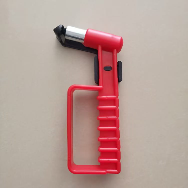 Red plastic car emergency escape hammer window breaker tool with a black and silver metal tip.