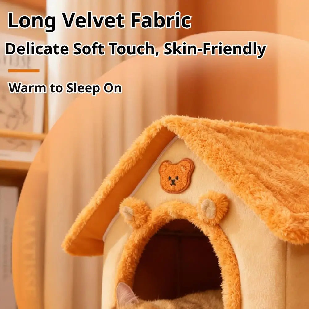 A cozy pet bed warm orange 33x32x30cm cat cave made of plush velvet fabric featuring embroidered bear ears and a teddy bear face patch on the roof.