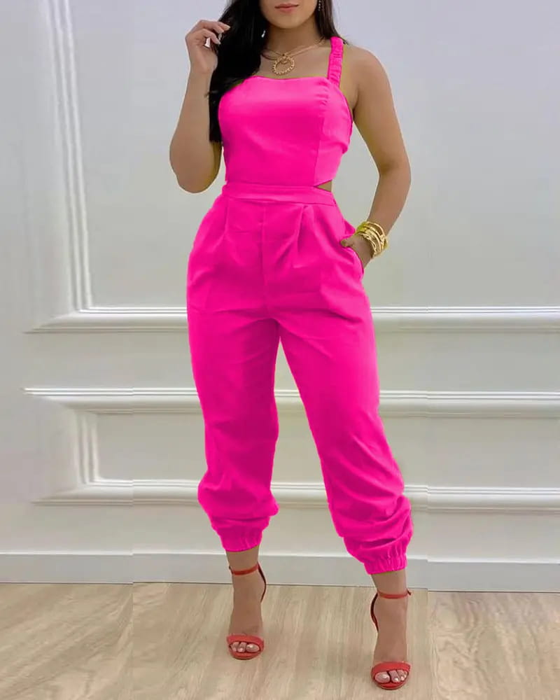 A vibrant fuchsia pink women summer printed cutout jumpsuit with a square neckline thin shoulder straps and side cutouts.