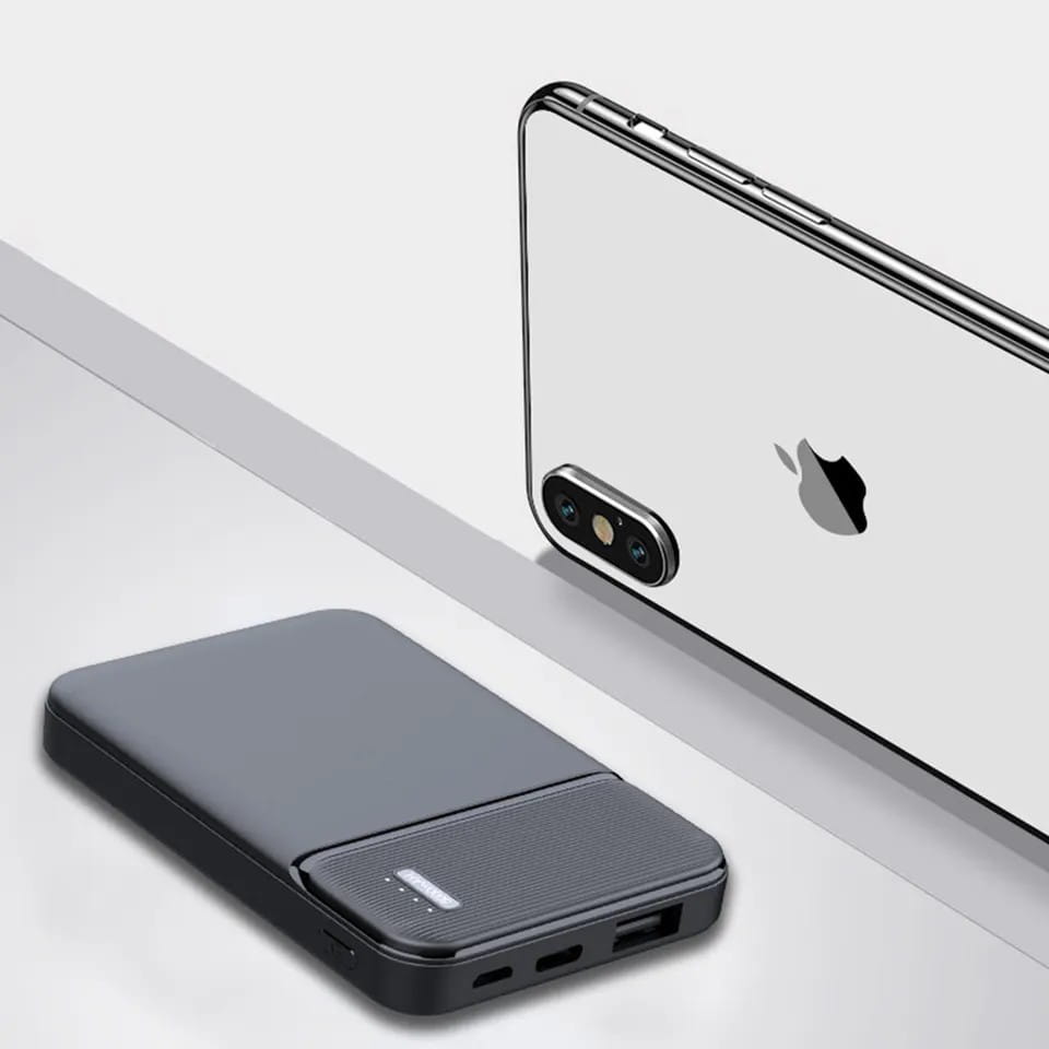Black rectangular 5000mAh portable power bank with textured surface and multiple charging ports for efficient mobile device charging.