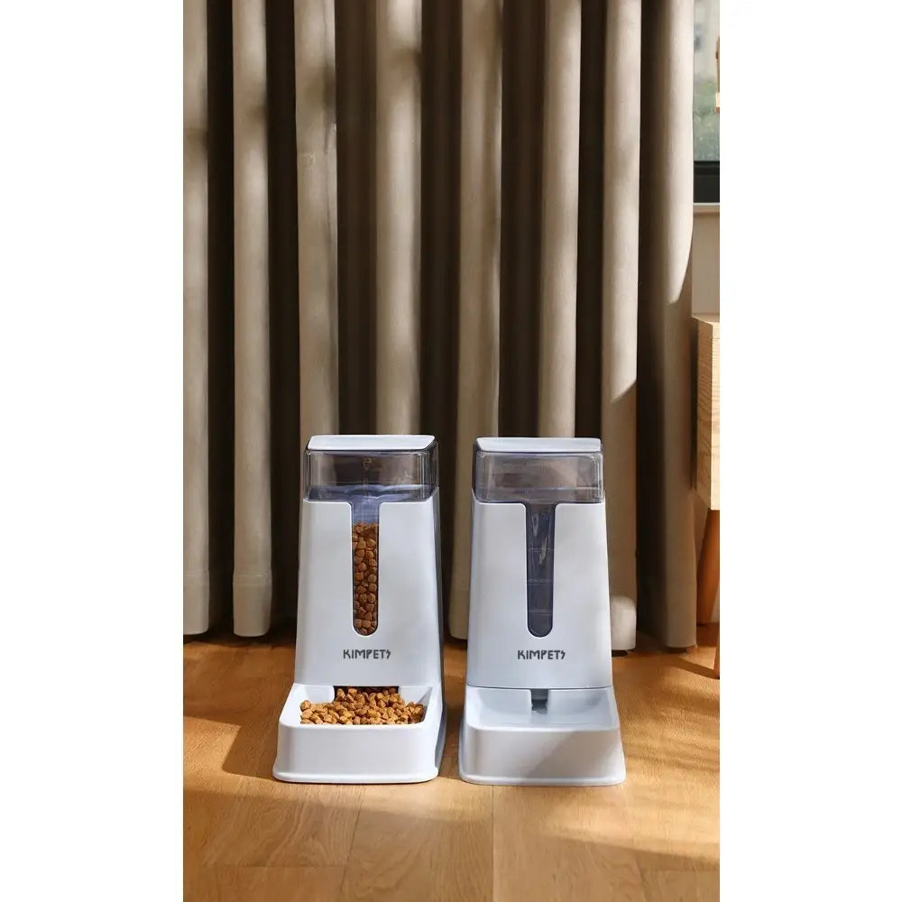 Two white kimpet automatic pet food dispensers with 3.5 liter transparent plastic compartments and small trays at the base.