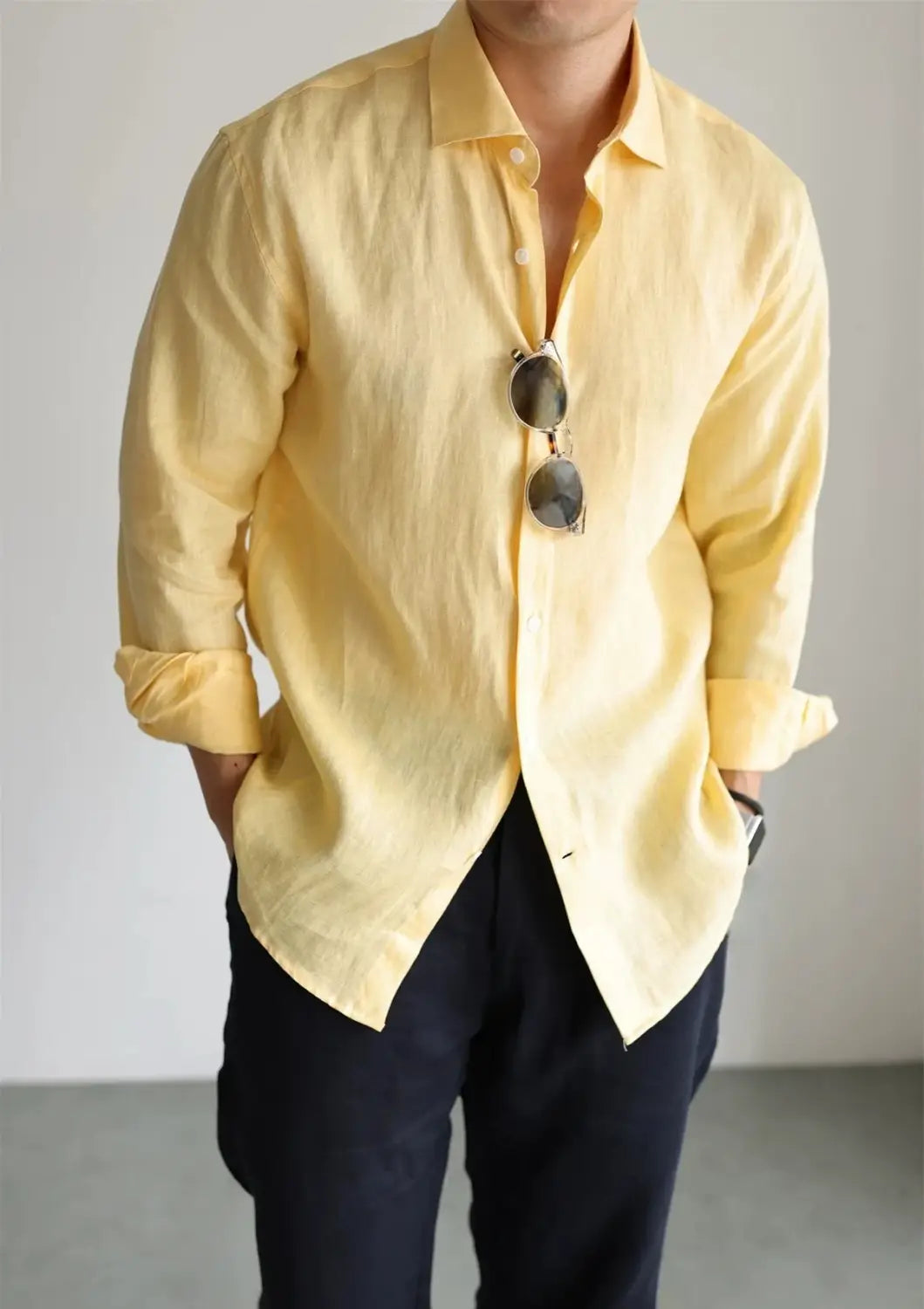 men cotton linen casual button down shirt in pale yellow featuring long sleeves, rolled cuffs, button front, and a collar made from breathable linen material.