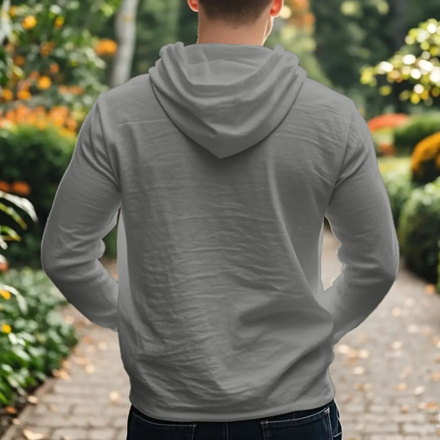 a men cotton linen long-sleeved hoodie henley shirt in gray with soft slightly wrinkled fabric and a relaxed fit