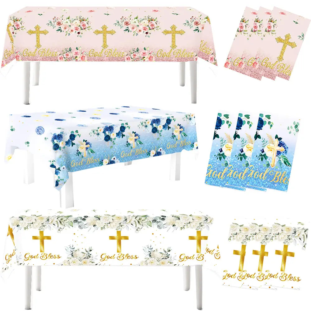 Set of three god bless baptism tablecloths with floral cross designs in pink, blue, and white, featuring matching napkins for party use.