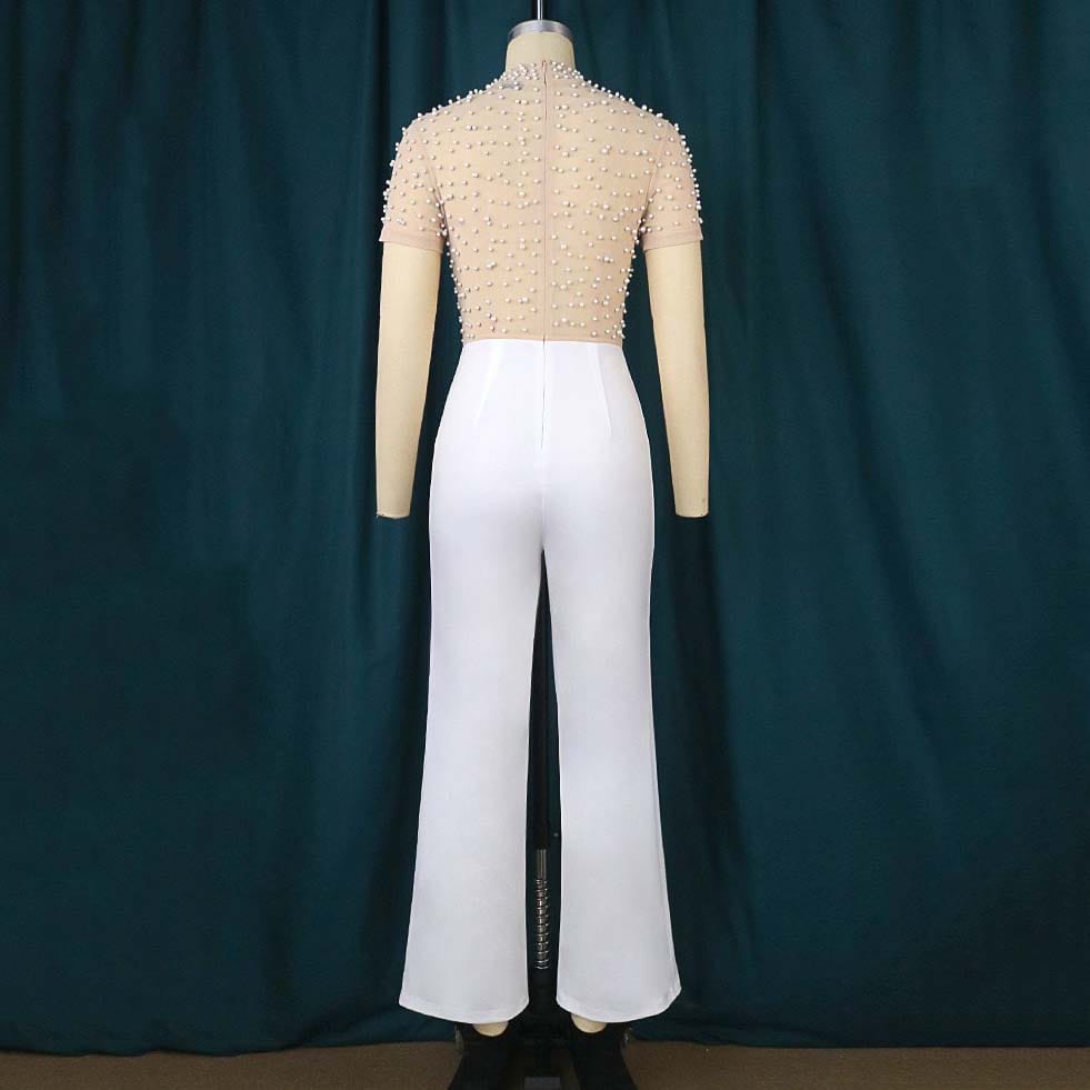 Beige beaded mesh jumpsuit paired with white high waist flared pants designed as a party outfit.