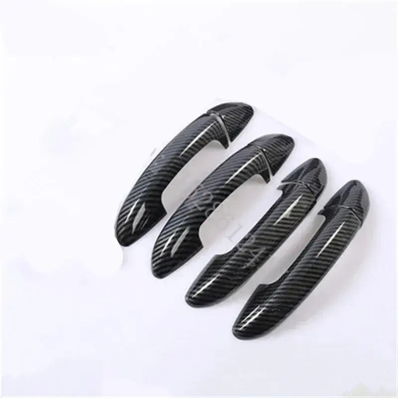 Set of four black carbon fiber textured car door handle covers designed for VW Passat.