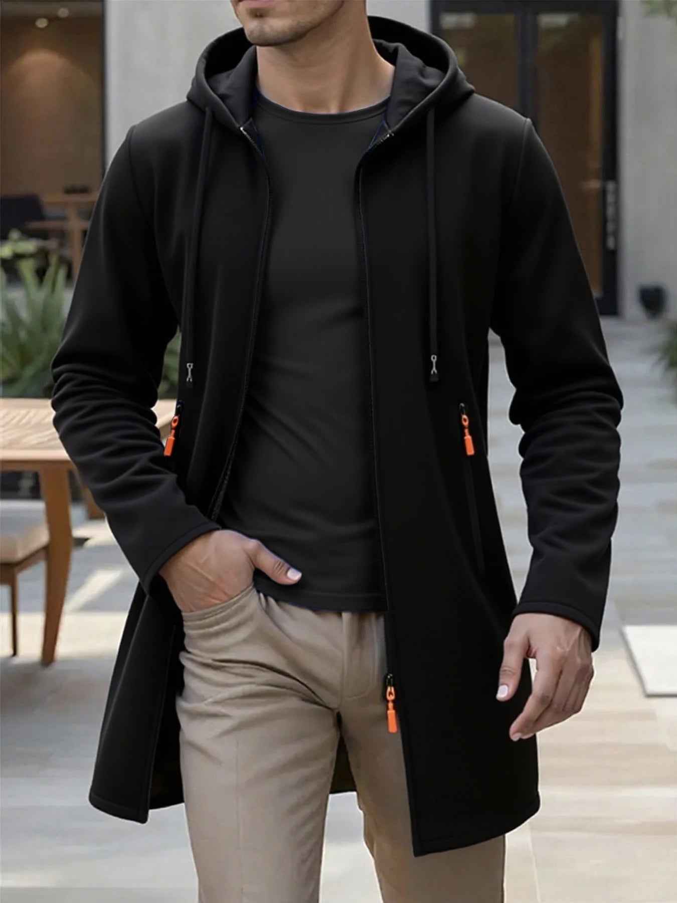 Men’s fleece lined knit hooded jacket in black with orange zipper pulls and a zip-up design.