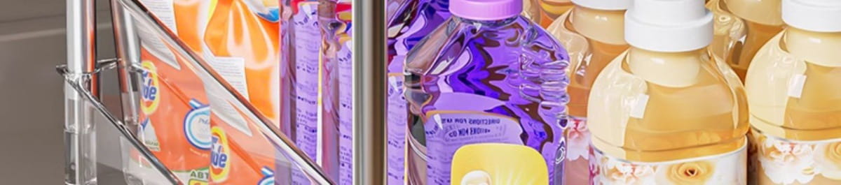 purple and yellow plastic bottles of sparkling water with purple caps stored on a 2-tier sliding under sink organizer storage holder