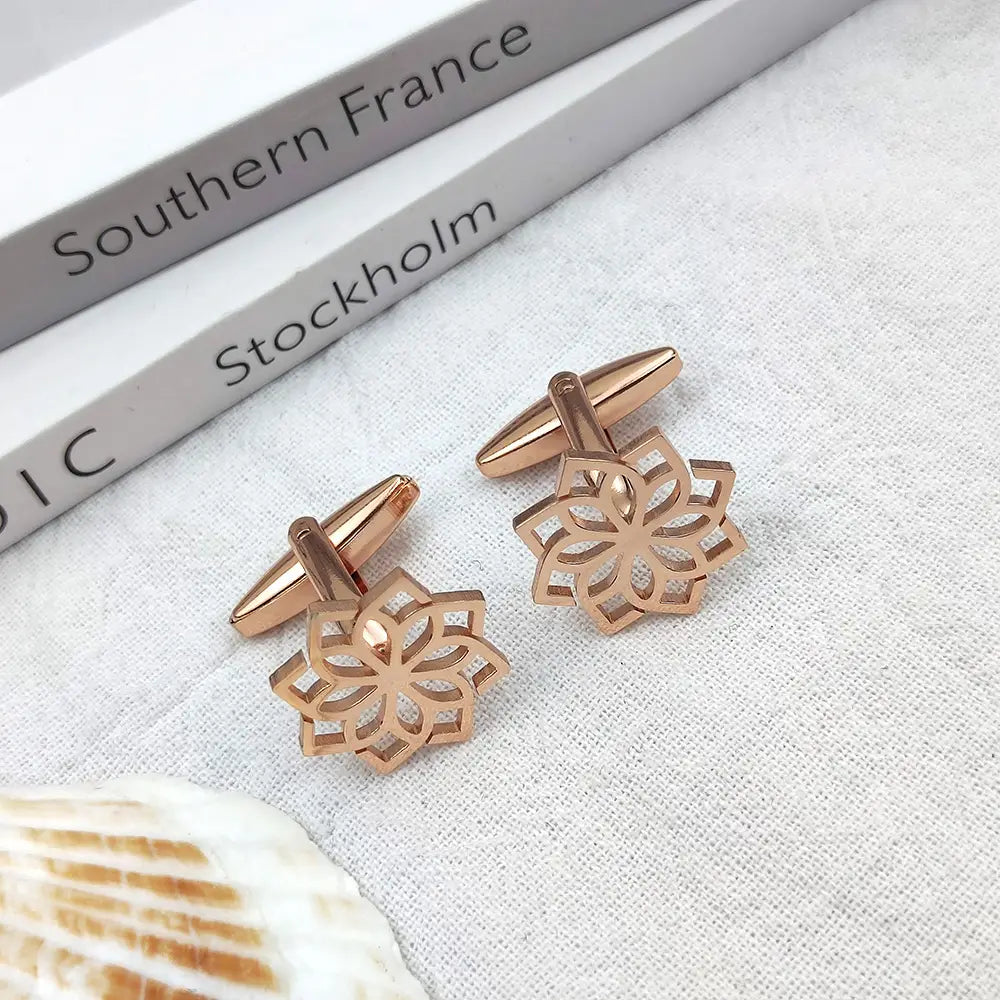 Rose gold-toned stainless steel floral cufflinks for men with intricately cut patterns and a sleek metallic finish.