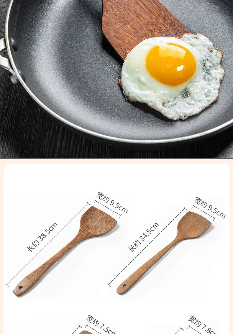 Wooden spatula with a smooth natural finish and slightly curved blade from a wooden kitchen utensil set designed for non-stick cookware.