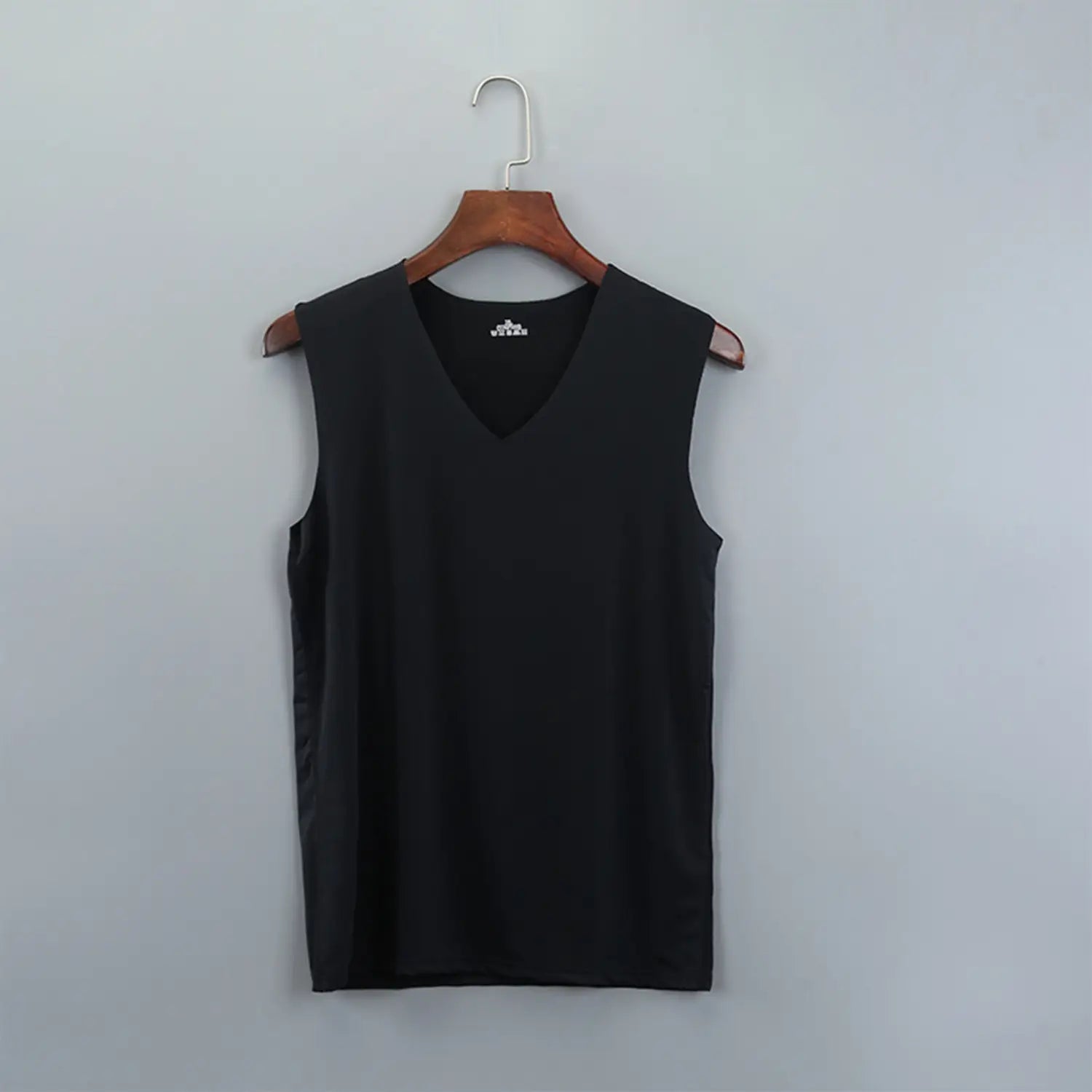 Black sleeveless v-neck men ice silk tank top hanging on a wooden hanger.
