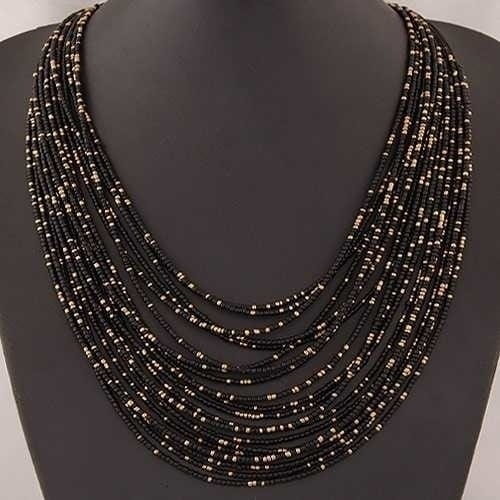 black beaded necklace with silver accents featuring a boho multi-layer bead statement design