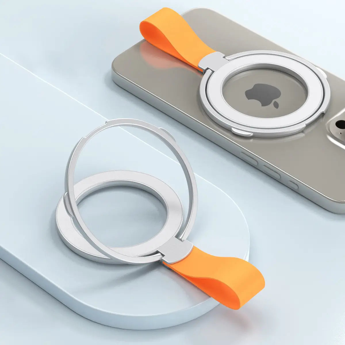 Silver magnetic phone ring holder with orange silicone strap showing the back side for Magsafe compatibility.