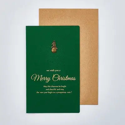 deep green christmas greeting card with gold foil lettering and a small golden bell charm at the top included in a christmas greeting cards set with gold foil envelopes.