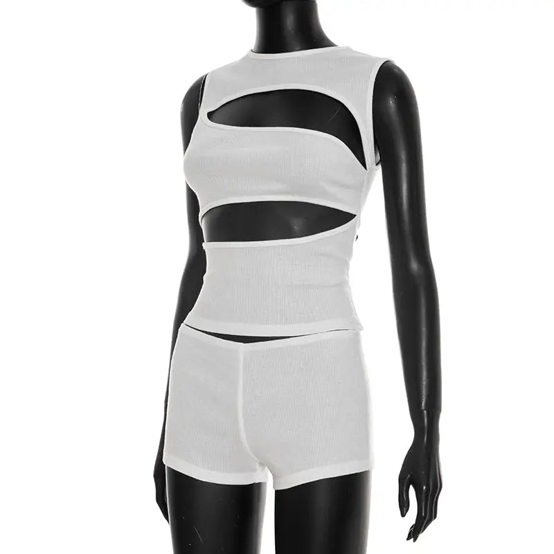White ribbed knit sleeveless top with bold black cutout panels and matching shorts set.