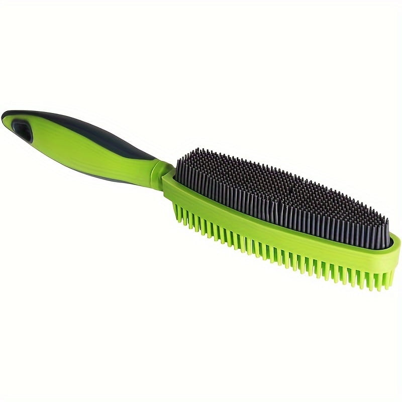 Silicone pet hair remover brush in bright green and black with dense flexible bristles designed for effective fur removal.