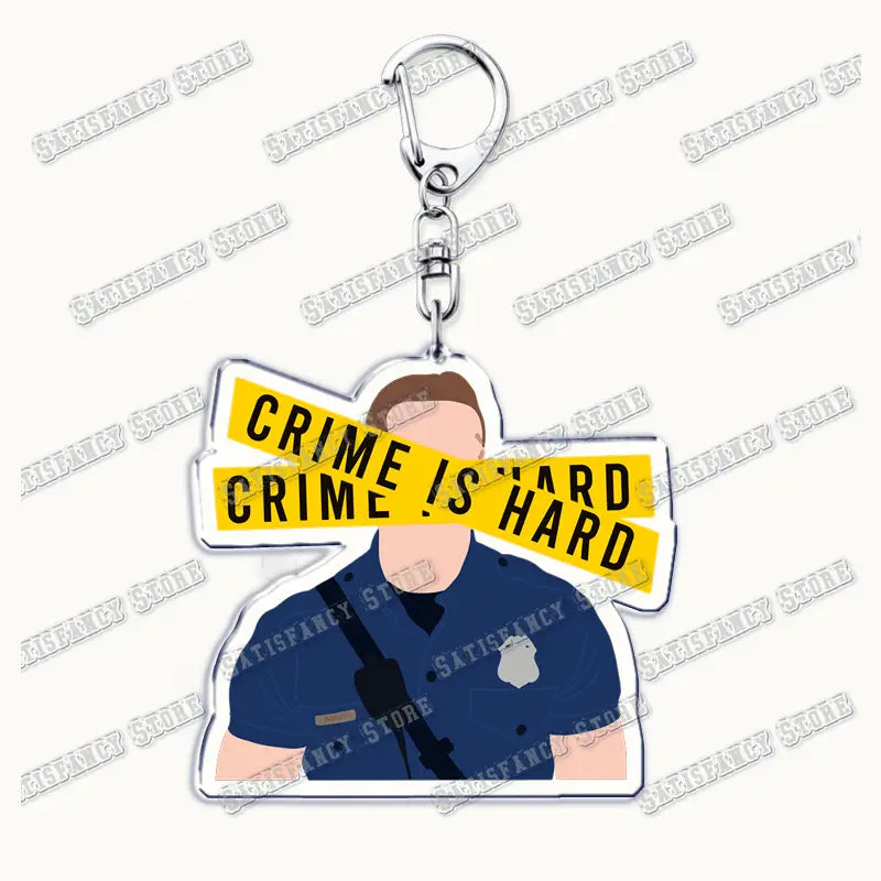 Clear acrylic keychain featuring a cartoon police officer with yellow crime scene tape across the face and black text, inspired by the 9-1-1 TV show, suitable as a firefighter gift.