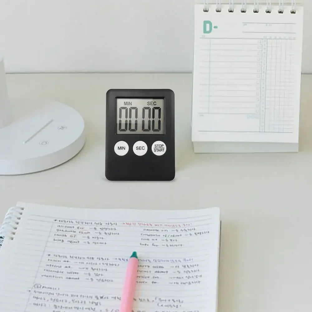 Black digital kitchen timer with a rectangular body, three circular buttons labeled min, sec, and stop/start, and an lcd screen displaying time in minutes and seconds used as a magnetic stopwatch.