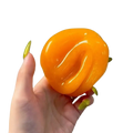 Handmade orange slushy squishy toy with vibrant orange glossy slime and subtle swirl patterns viewed from the front