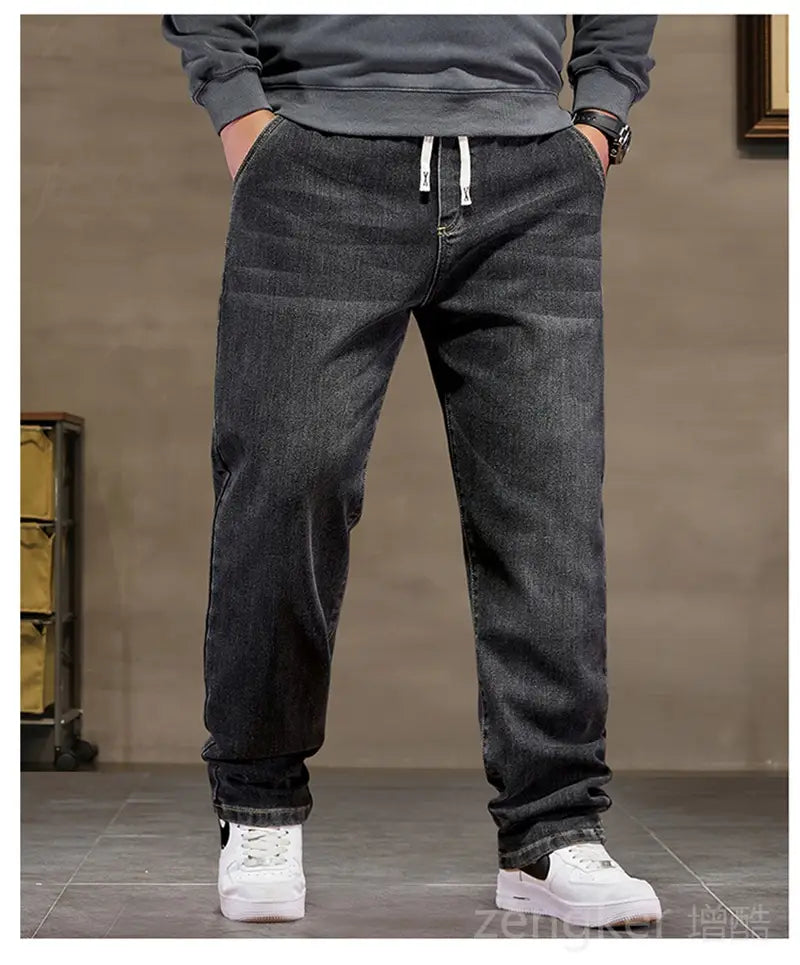Plus size elastic waist loose straight dark-wash denim jeans with white drawstrings at the waistband.