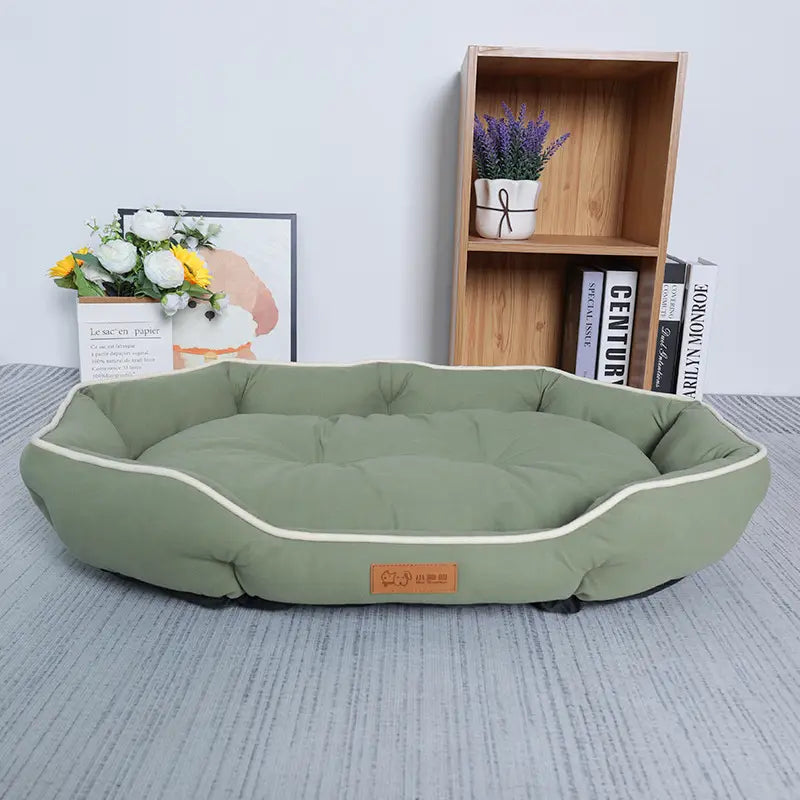 Large pink plush sofa sleeping bed for dogs in olive green with cream-colored piping and soft cushioned interior.