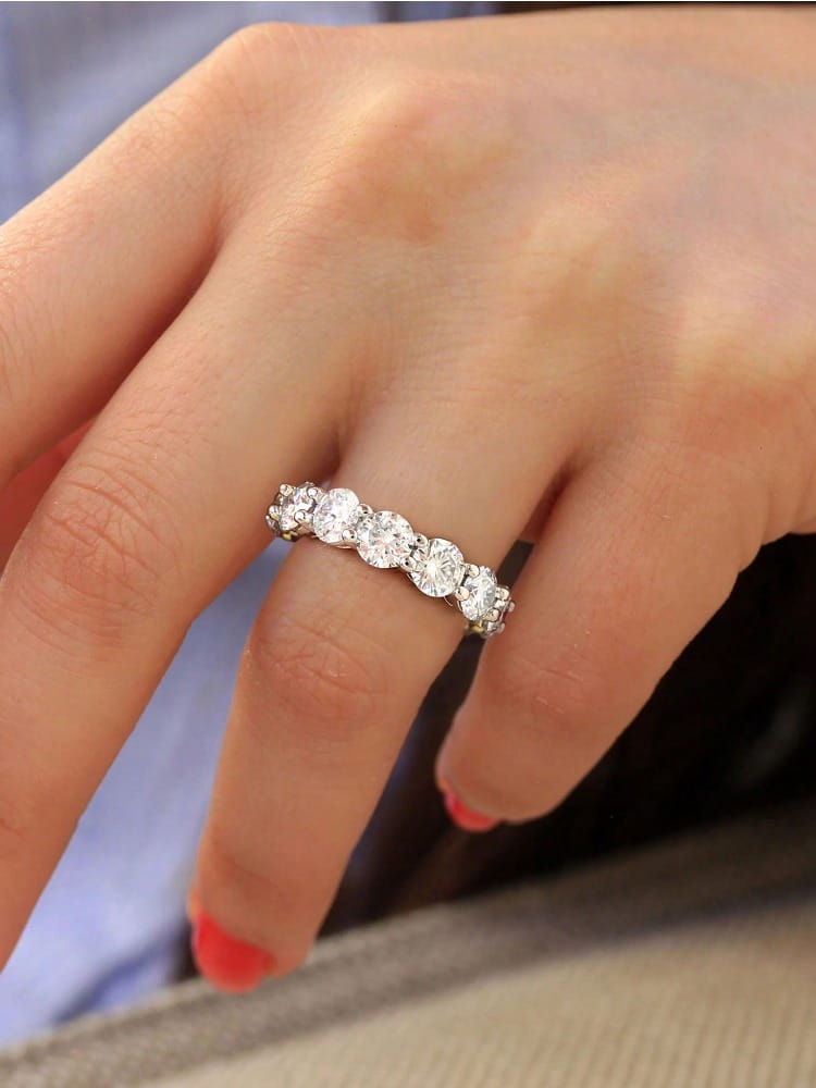 A sterling silver zircon ring for women featuring a sparkling diamond eternity band with five prominent round-cut stones in a sleek silver setting.