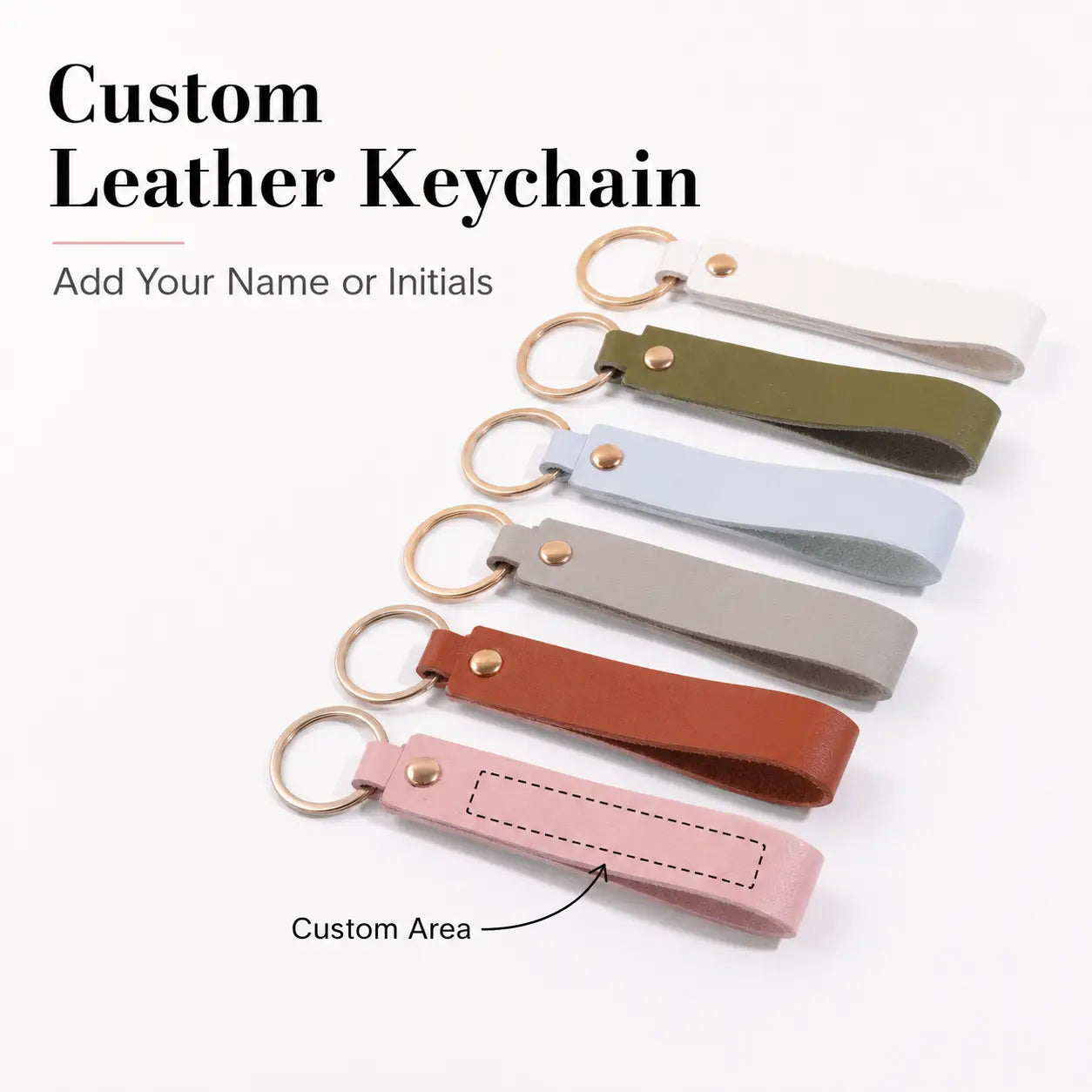 Custom name pink leather keychain with a smooth minimalist design in various solid colors including white olive green light blue gray brown and pink featuring a gold toned metal ring and rivet.