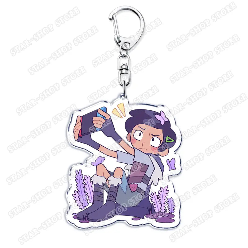 Purple and white acrylic Amphibia anime keychain featuring a cartoon character taking a selfie with a smartphone.