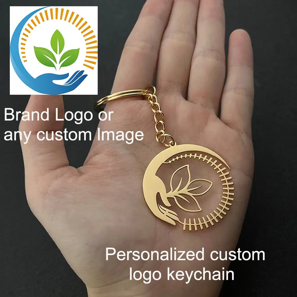 Gold-colored circular metal keychain with laser-cut leaf design and stitching details for custom engraved metal keychains personalized gifts.