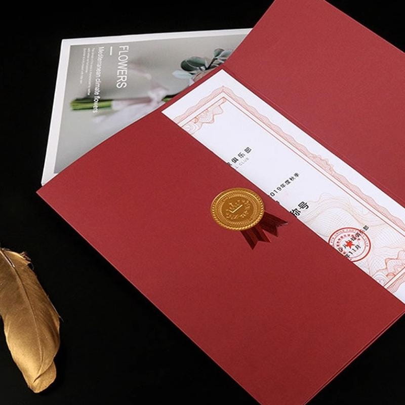 a4 certificate holder diploma document folder in red leather with a gold wax seal and red ribbon securing the certificate inside