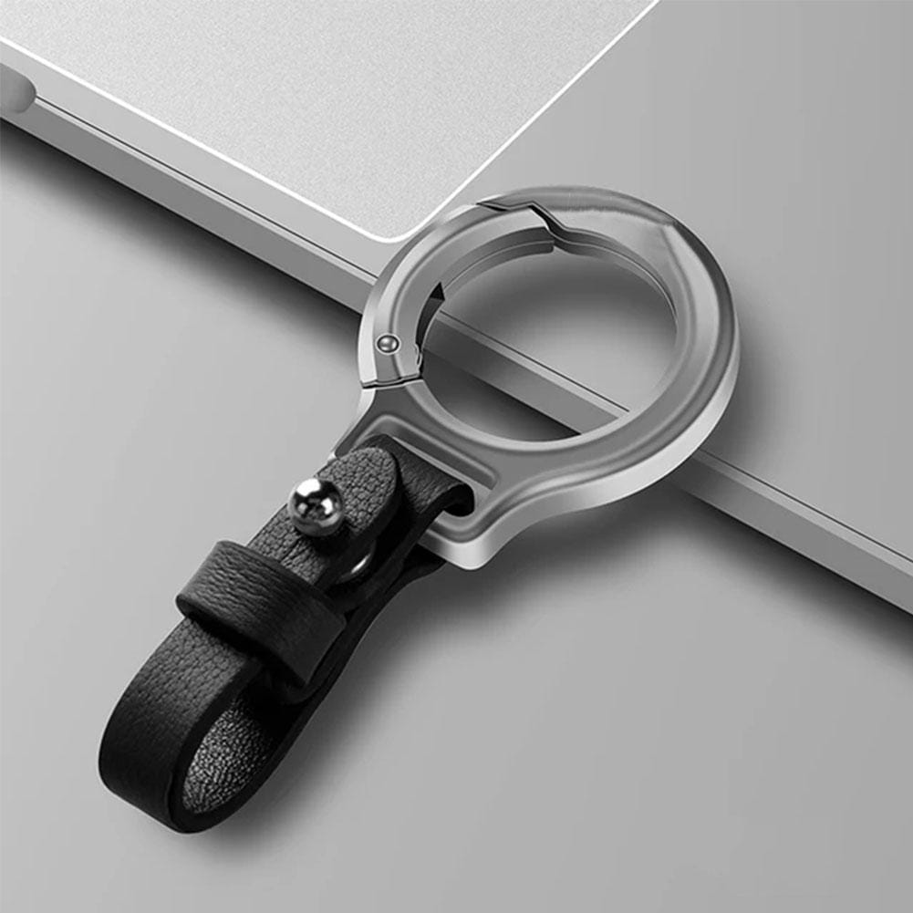 Silver-toned metal phone stand with a black leather strap and a small metallic ball accent featured as a leather car keychain durable metal key ring holder gift.