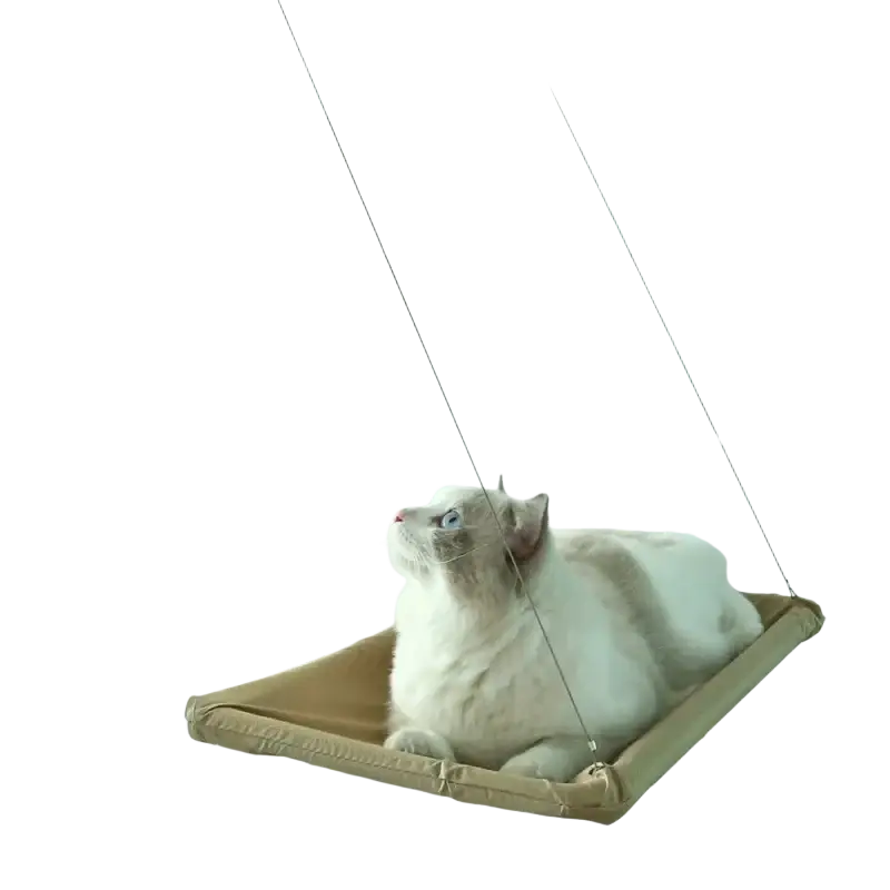 Beige fabric cat hammock aerial hanging suspended by thin wires from a white metal frame viewed from the side