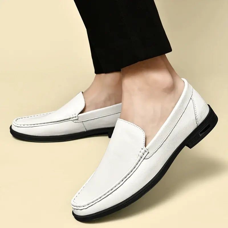 Men genuine leather slip-on dress loafers in white with black soles and stitching details displayed from the front.