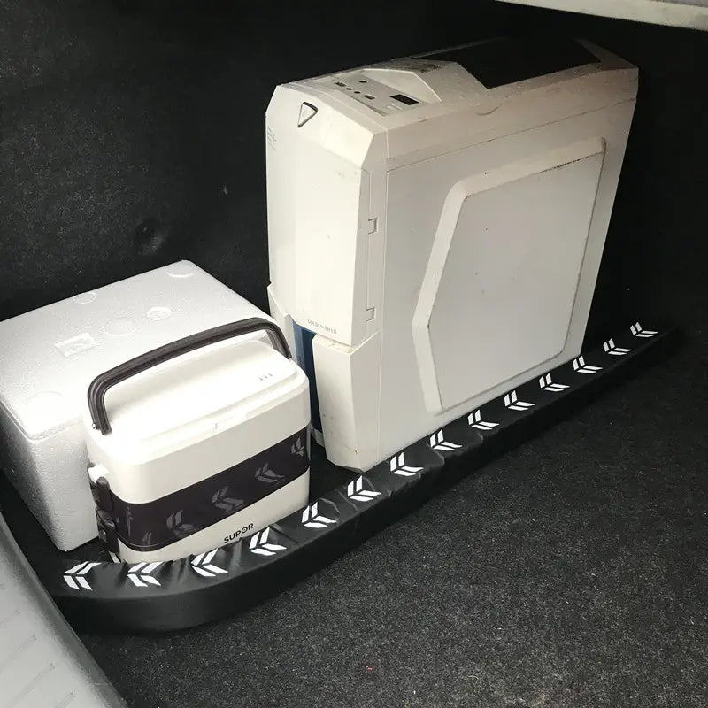 Black rubber car trunk organizer mat with white arrow patterns featuring flexible anti-collision stick design.