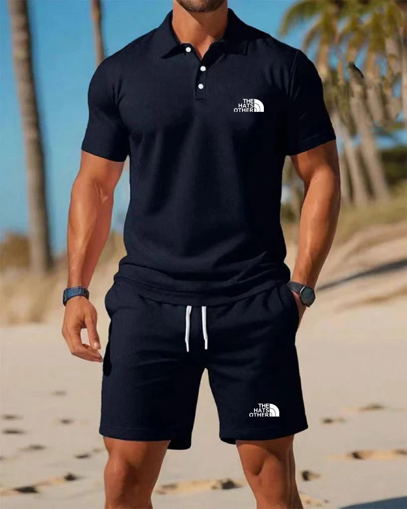 Men’s knit polo and shorts set featuring a navy blue The North Face polo shirt with white logo and buttoned collar.