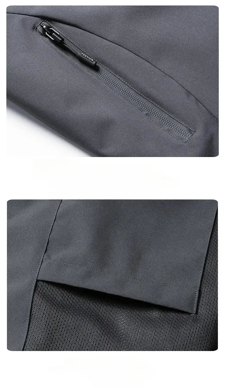 Men waterproof hiking jacket hooded windbreaker in dark gray sleek fabric with subtle textured weave and zippered pocket.