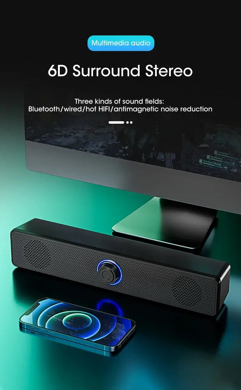 Black rectangular Bluetooth computer speaker wireless desktop soundbar with perforated speaker grilles and a central circular control knob illuminated by blue light.