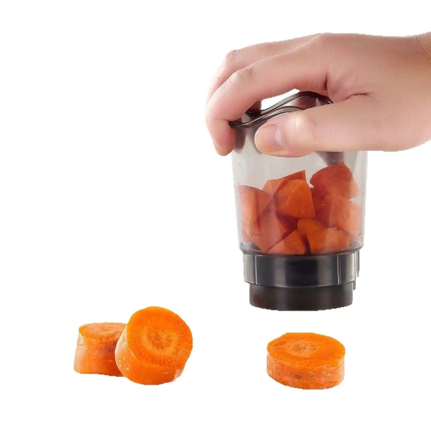 Transparent plastic handheld fruit and vegetable chopper slicer with black base and handle holding chopped orange carrots.