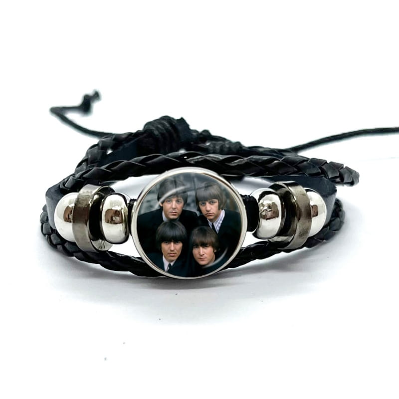 Black braided leather bracelet featuring a circular glass dome charm with the Beatles design and silver-toned metal beads.