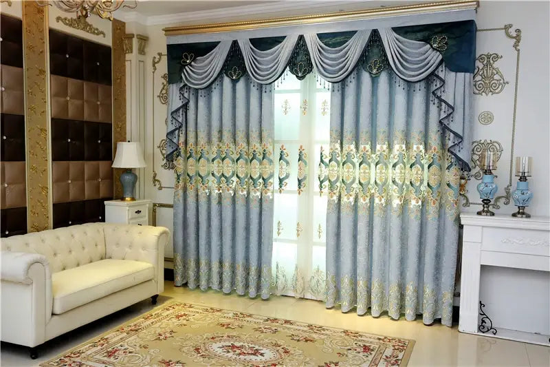 Luxurious light blue embroidered living room curtains with intricate gold and green detailing and a decorative valance designed for french window use.