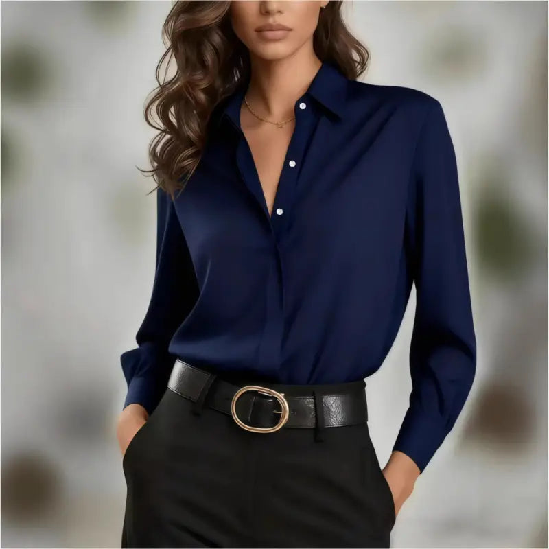 Navy blue satin button-down women’s office shirt with white buttons and long sleeves.
