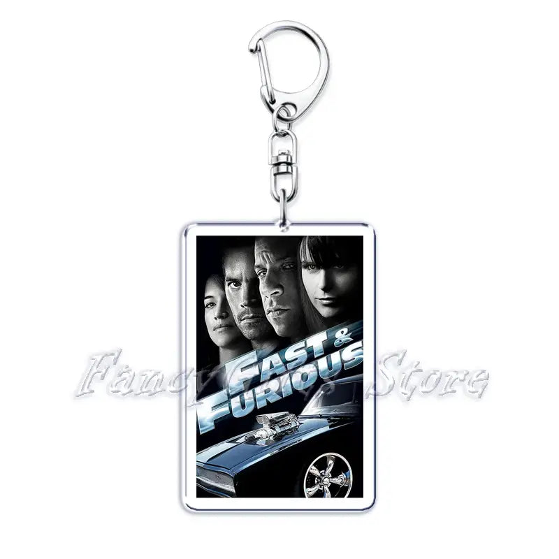 Silver rectangular acrylic keychain featuring a black and white fast and furious movie poster with bold blue and white lettering from the movie poster acrylic keychain set.