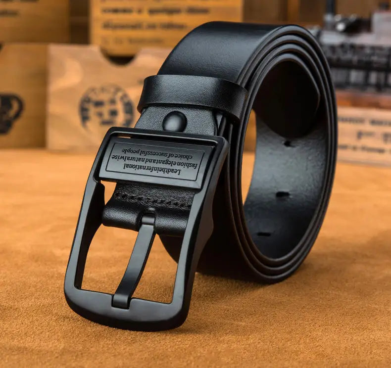 Black leather belt with a matte-finish metal buckle featuring engraved text designed for casual jeans.