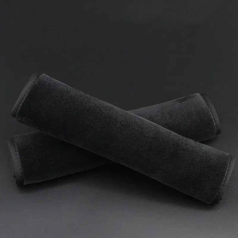 black plush-textured car seat cushion covers designed as seat belt shoulder pads for comfort and protection in vehicles