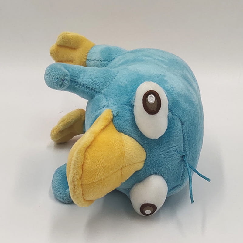 Ein blaues Schleifen-Tauchenten-Plüschtier mit weichem Plüschmaterial, mit einem gelben Schnabel und Füßen sowie großen weißen Augen mit braunen Pupillen.