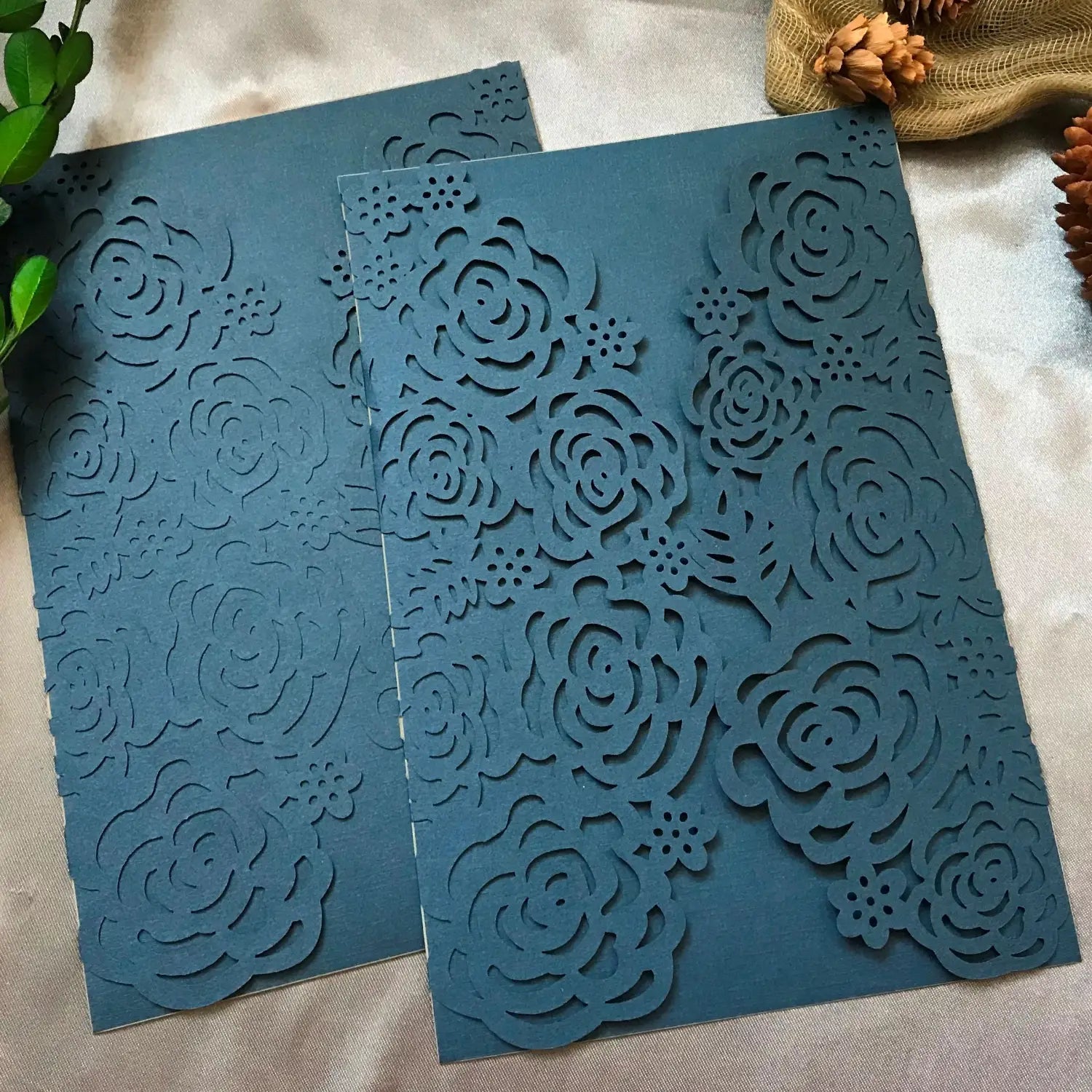 Elegant navy blue laser cut wedding invitation cards 10 pack featuring intricate rose and floral paper patterns.